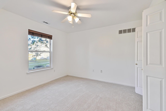 carpeted spare room featuring ceiling fan