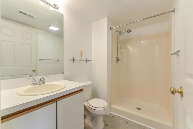 bathroom with a shower, vanity, and toilet