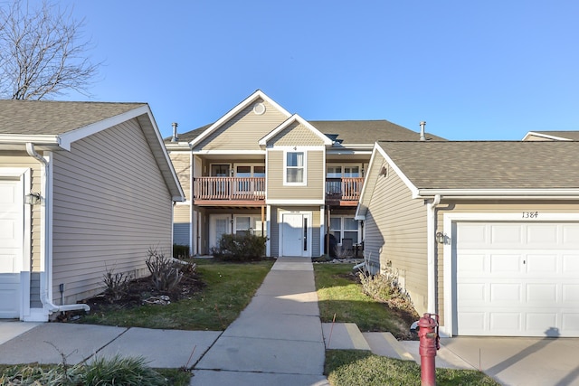 view of front of house featuring a garage and a balcony