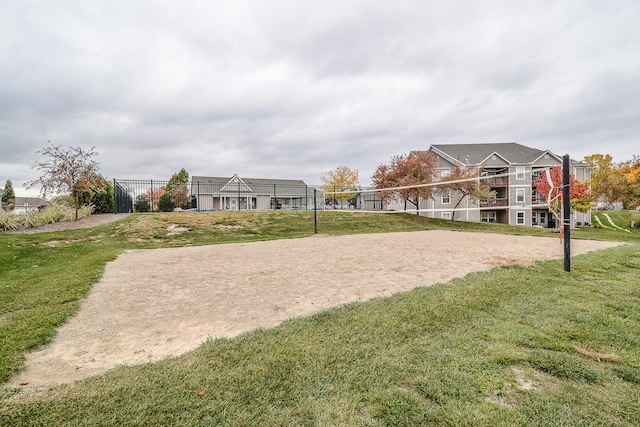 view of community featuring volleyball court and a yard