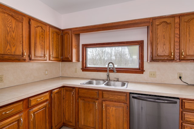 kitchen featuring tasteful backsplash, stainless steel dishwasher, and sink