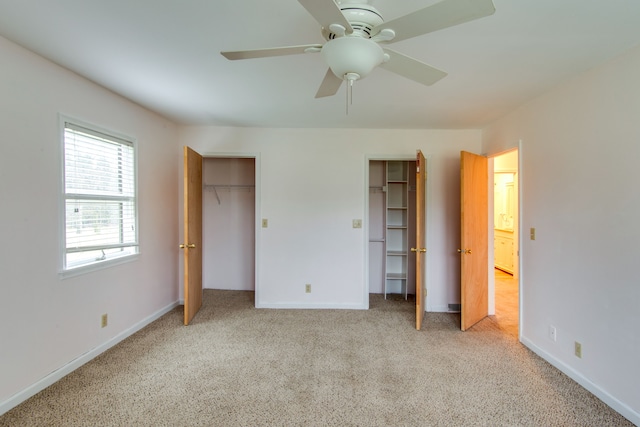 unfurnished bedroom featuring ceiling fan and light carpet