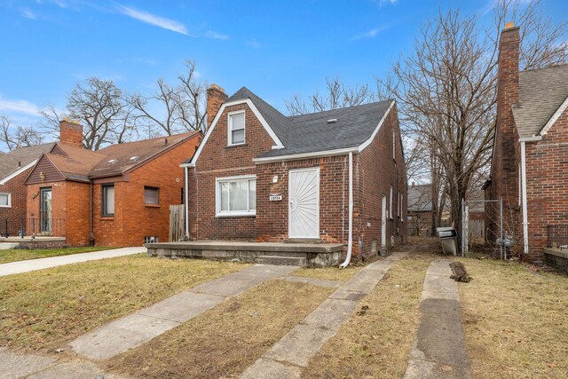 bungalow-style home with a front yard