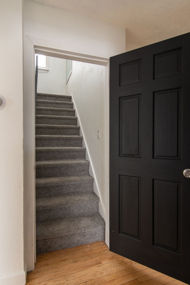 stairway featuring hardwood / wood-style floors