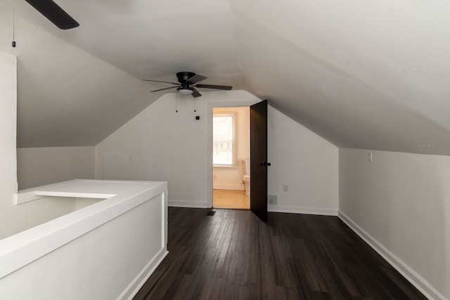 bonus room with vaulted ceiling, ceiling fan, and dark hardwood / wood-style flooring