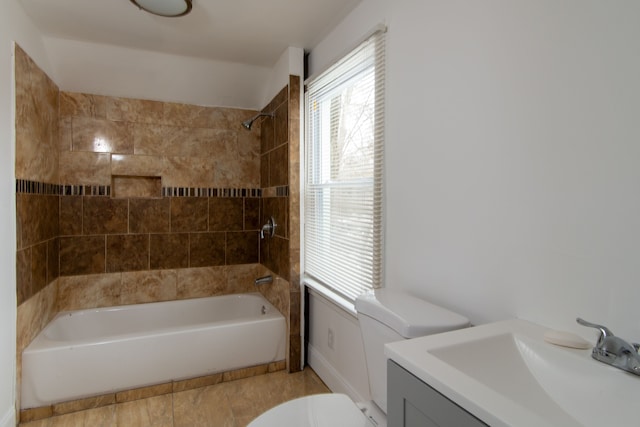 full bathroom featuring tiled shower / bath combo, toilet, and vanity