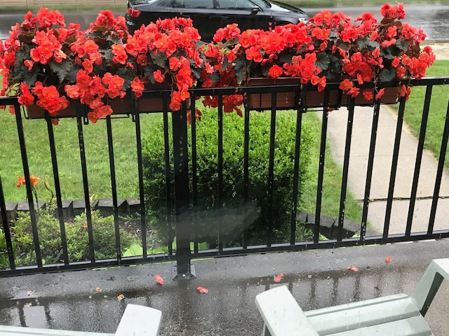 view of gate with a lawn