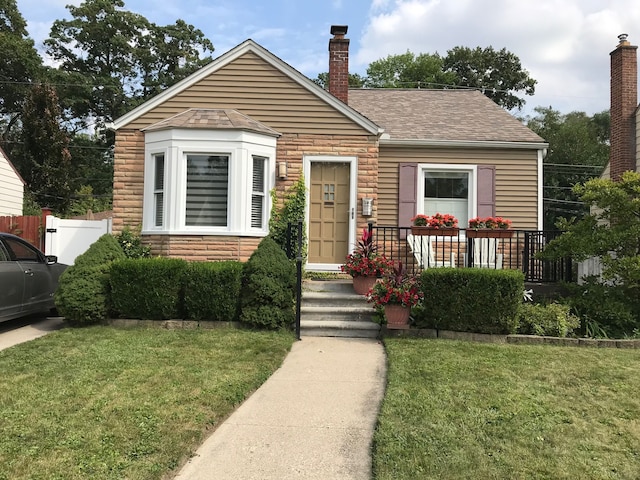 bungalow-style home featuring a front lawn