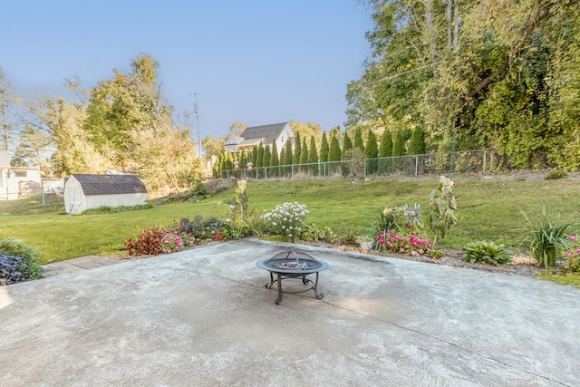 view of patio / terrace with a fire pit and a shed