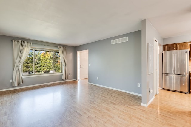 spare room featuring light hardwood / wood-style flooring