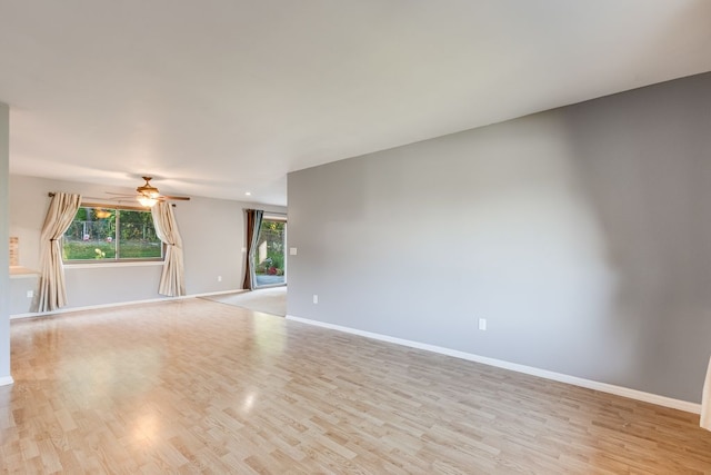 spare room featuring ceiling fan and light hardwood / wood-style flooring