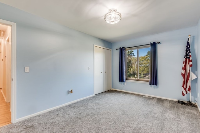 unfurnished bedroom featuring a closet and carpet