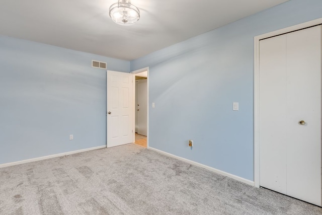 empty room featuring light colored carpet