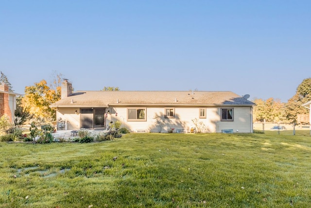 back of house with a lawn and a patio area