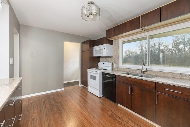 kitchen featuring dark brown cabinets, sink, dark hardwood / wood-style floors, and white appliances