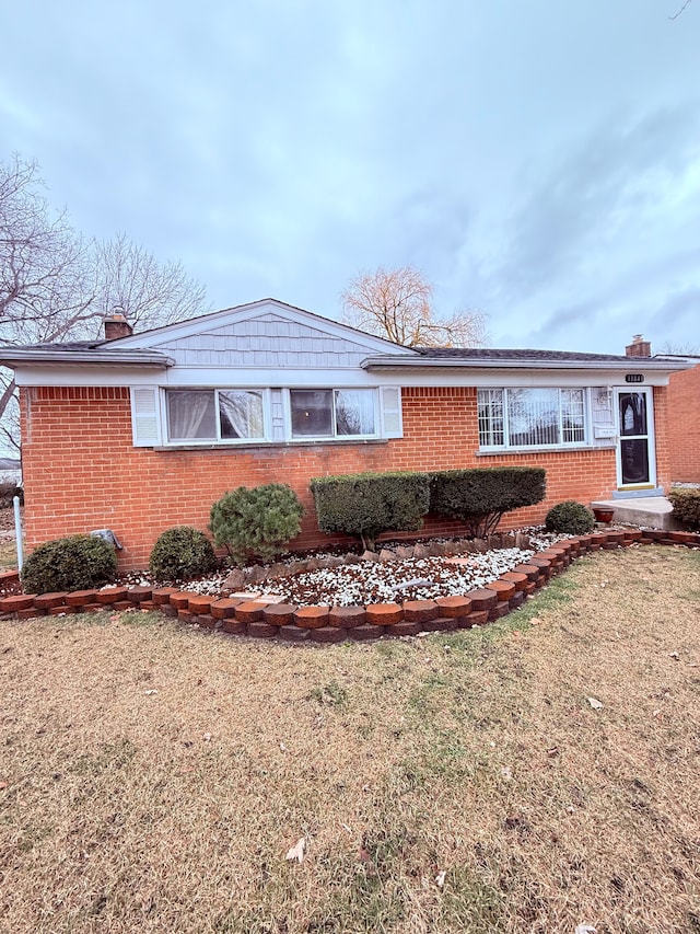 view of side of property with a lawn