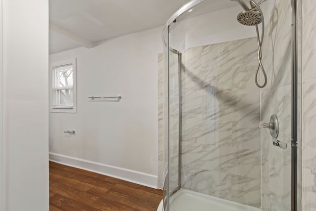 bathroom featuring hardwood / wood-style flooring and walk in shower