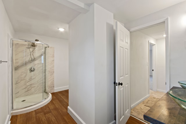 bathroom featuring wood-type flooring and walk in shower