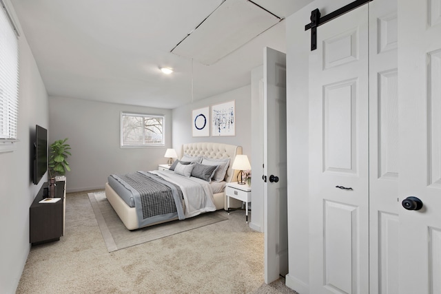 carpeted bedroom with a barn door