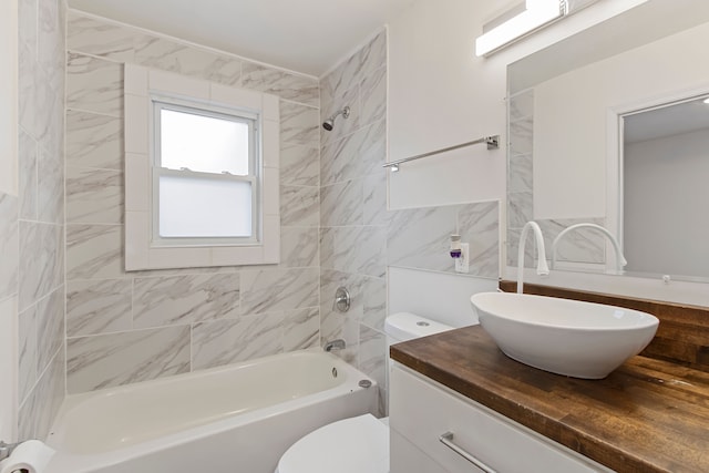 bathroom with tub / shower combination, vanity, and toilet