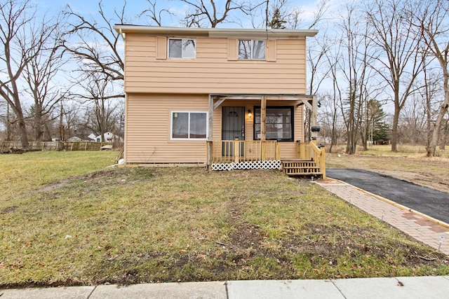 front of property with covered porch and a front lawn