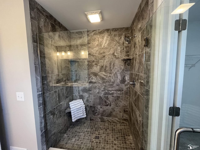 bathroom featuring a shower with shower door