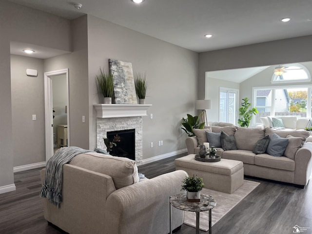 living room with a fireplace, dark hardwood / wood-style flooring, and ceiling fan