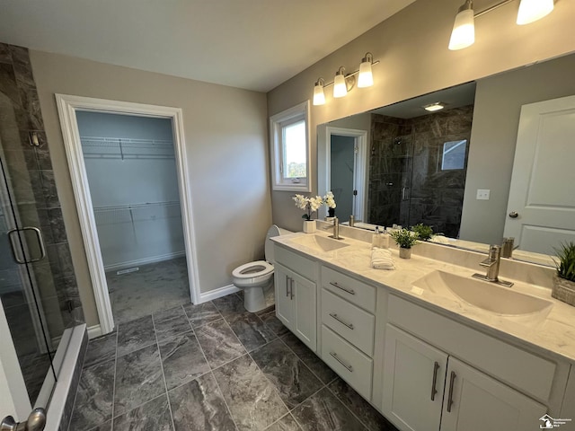 bathroom featuring vanity, toilet, and walk in shower