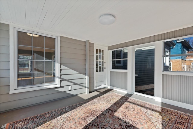 view of exterior entry with a porch