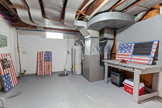 basement with a workshop area, gas water heater, and heating unit