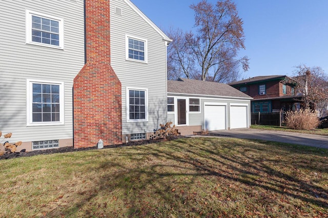 view of front of house with a front yard and a garage