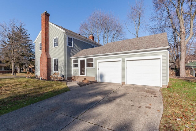 view of front of house with a front yard and a garage