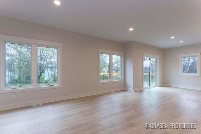 spare room with light hardwood / wood-style flooring