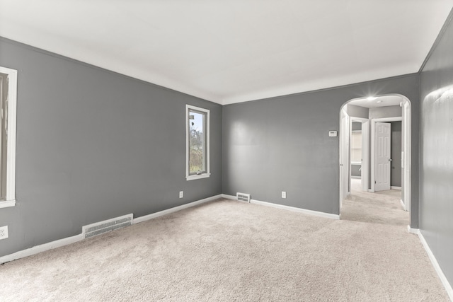 unfurnished room with light carpet