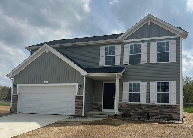 craftsman-style home featuring driveway, stone siding, and a garage