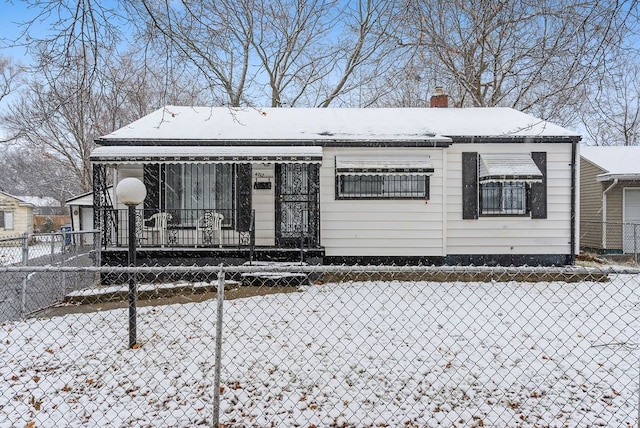 view of snow covered rear of property