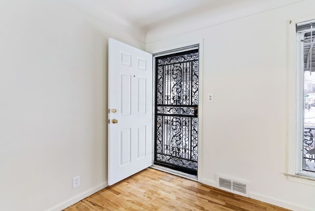 foyer entrance with light hardwood / wood-style floors