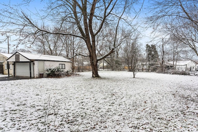 yard covered in snow with a garage