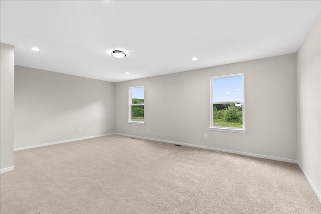 carpeted spare room with a healthy amount of sunlight