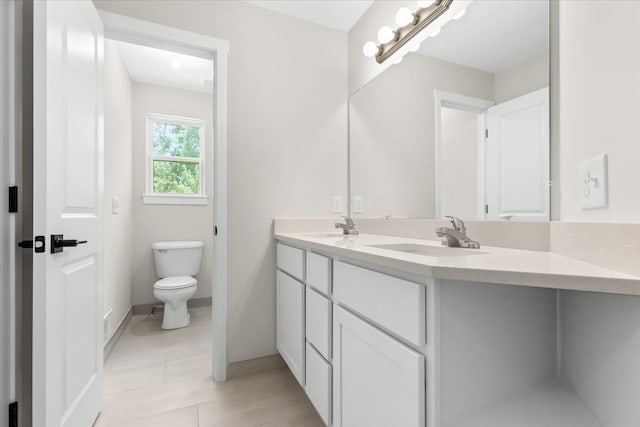 bathroom featuring vanity and toilet