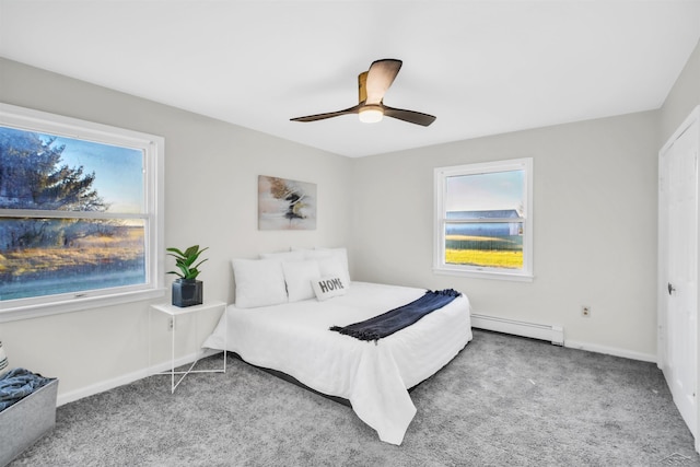 carpeted bedroom featuring baseboard heating and ceiling fan