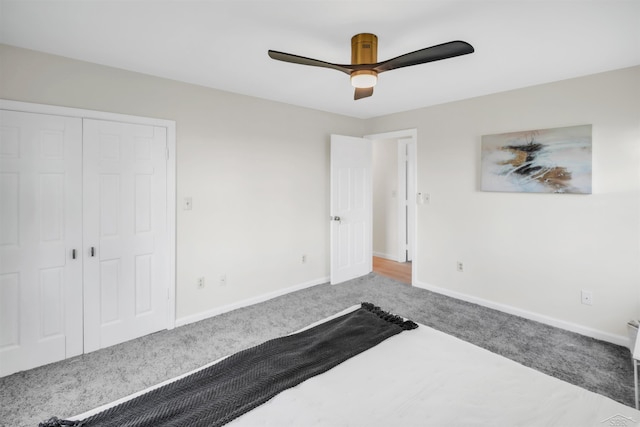 unfurnished bedroom featuring carpet floors, a closet, and ceiling fan