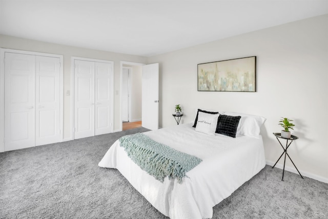 bedroom featuring carpet flooring and multiple closets