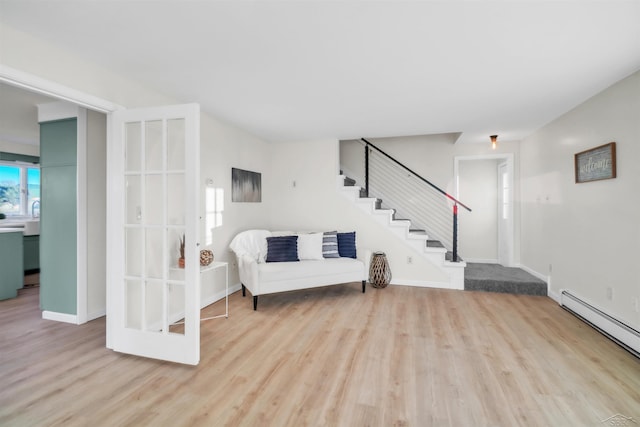 sitting room featuring a baseboard radiator and light hardwood / wood-style floors