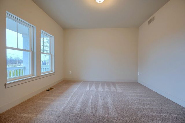 unfurnished room featuring light colored carpet