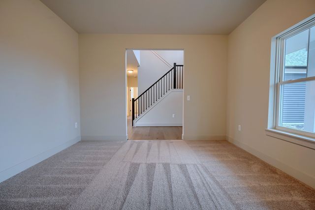 unfurnished living room with light carpet and a healthy amount of sunlight