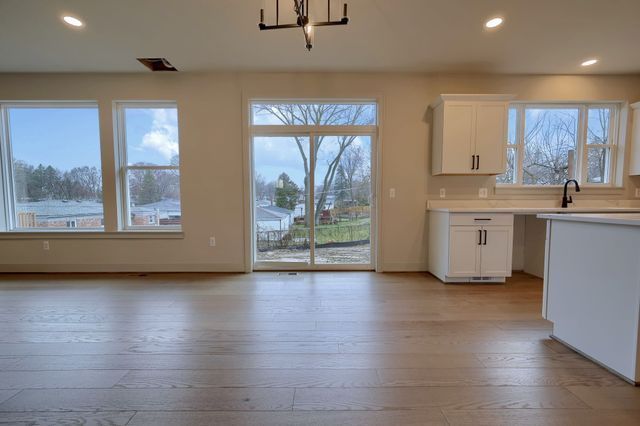 kitchen featuring white cabinets, light hardwood / wood-style flooring, and a wealth of natural light