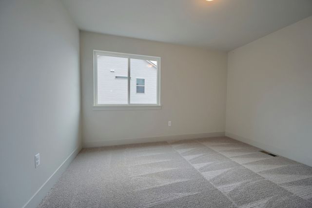 unfurnished room with light colored carpet