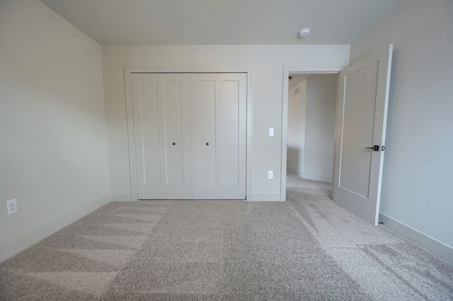 unfurnished bedroom featuring carpet floors and a closet