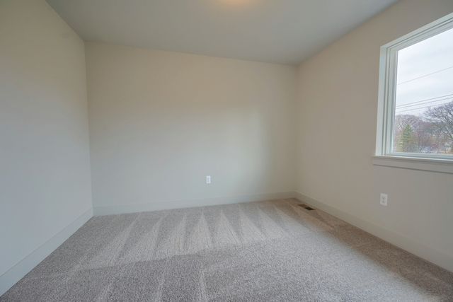 carpeted spare room with a healthy amount of sunlight